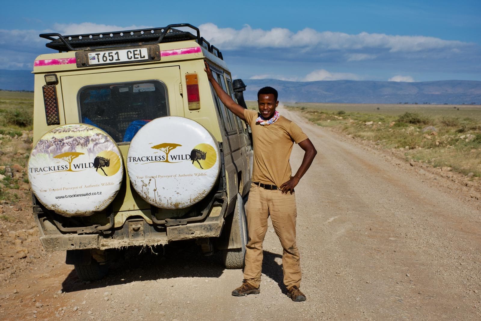 Our guide beside the vehicle on a park road