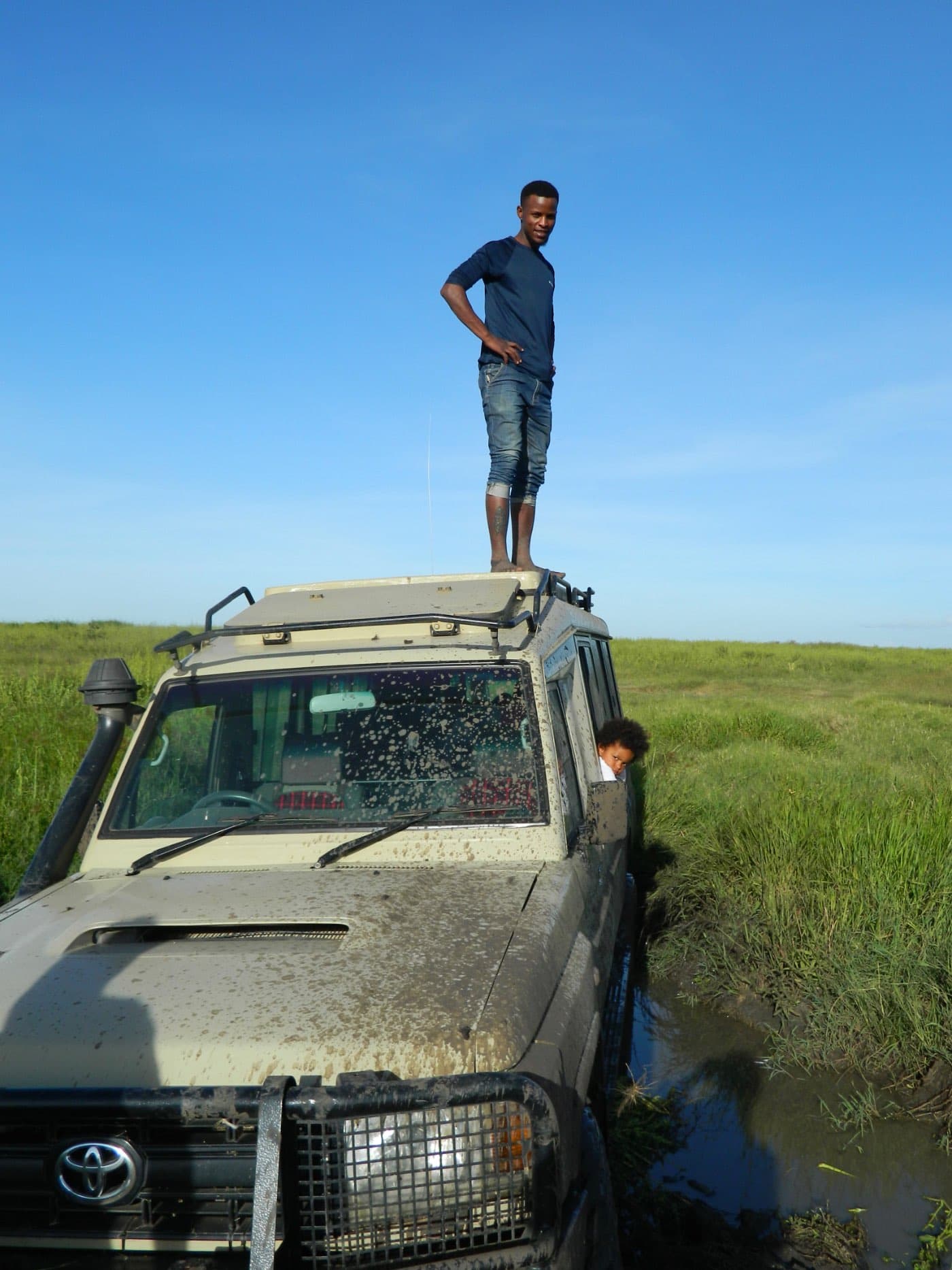 Our crew working the vehicle out of deep mud in the wet season