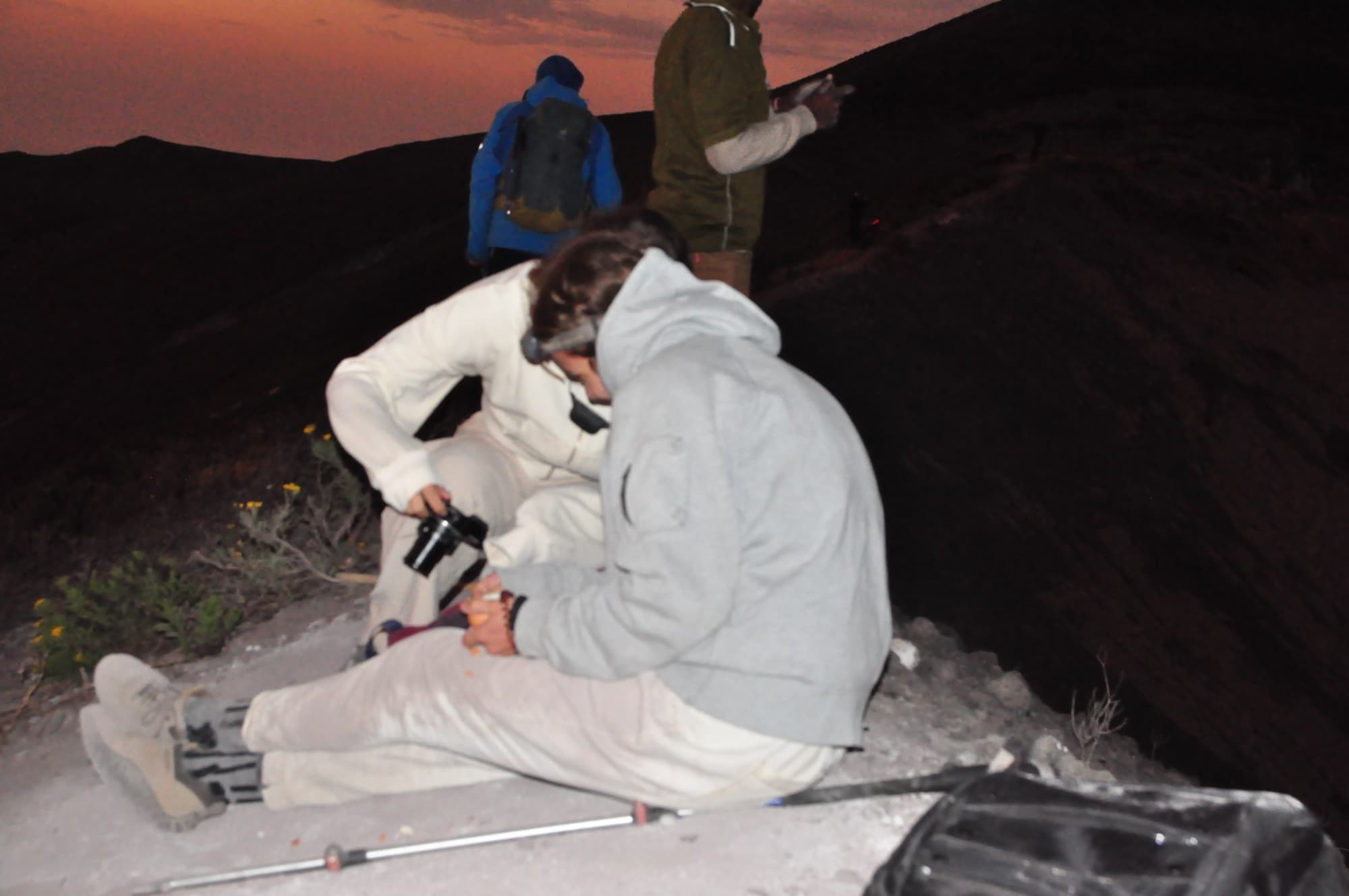 Climbers on the mountain at dawn, headlamps still on