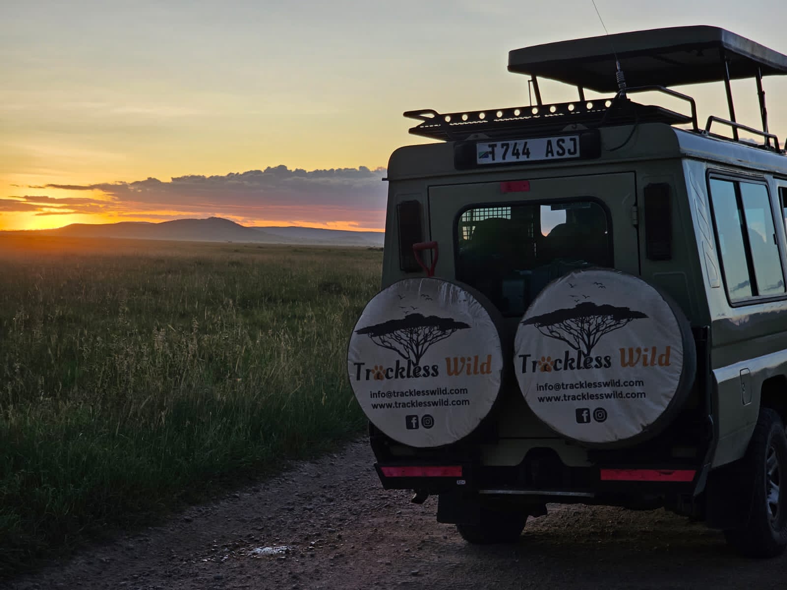 A Trackless Wild Land Cruiser on a track at sunrise, open plain stretching to the horizon